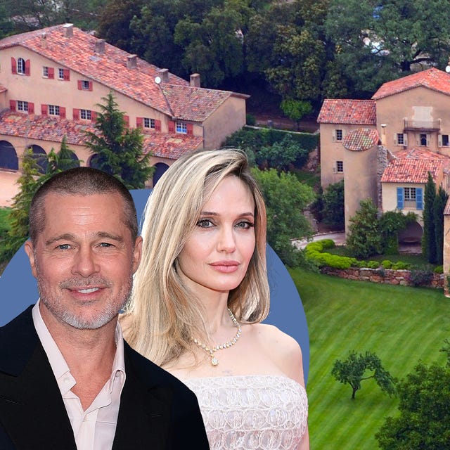 Aerial view of a large, elegant villa surrounded by lush greenery.