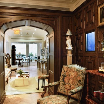 Interior view showcasing a stylish room with ornate wooden paneling and furniture. Interior view showcasing a stylish room with ornate wooden paneling and furniture.