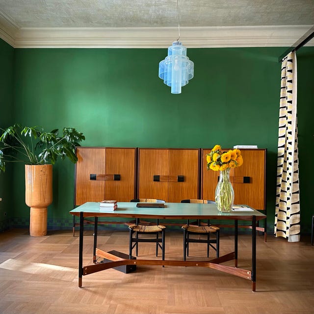 Interior of a stylish room featuring a green wall and modern furniture. Interior of a stylish room featuring a green wall and modern furniture.