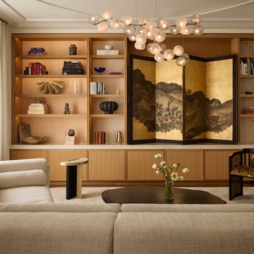 Modern living room with a decorative folding screen and stylish furniture.