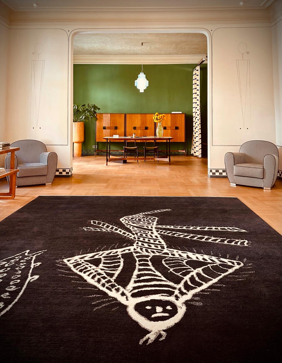 Interior space featuring a prominent rug design and modern furniture. Interior space featuring a prominent rug design and modern furniture.