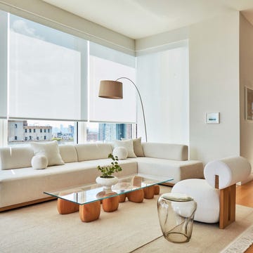 Modern living room with a sectional sofa, coffee table, and artwork.