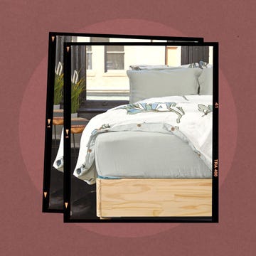 A neatly made bed with a decorative quilt and pillow.