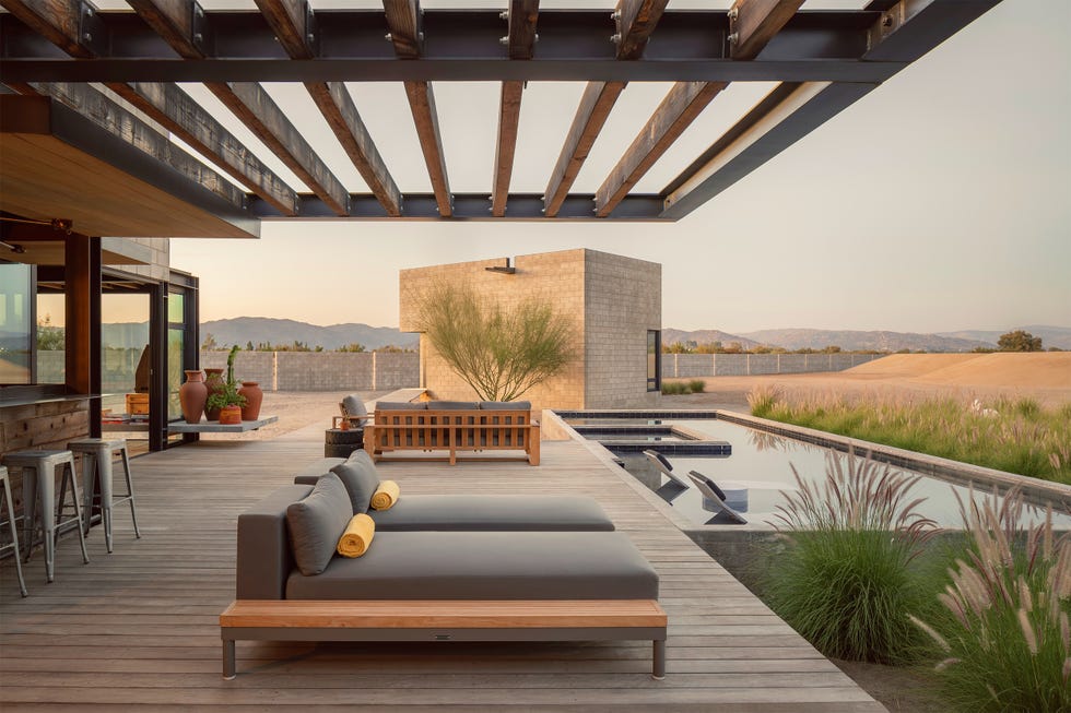 Modern outdoor seating area with pool and landscaping. Modern outdoor seating area with pool and landscaping.
