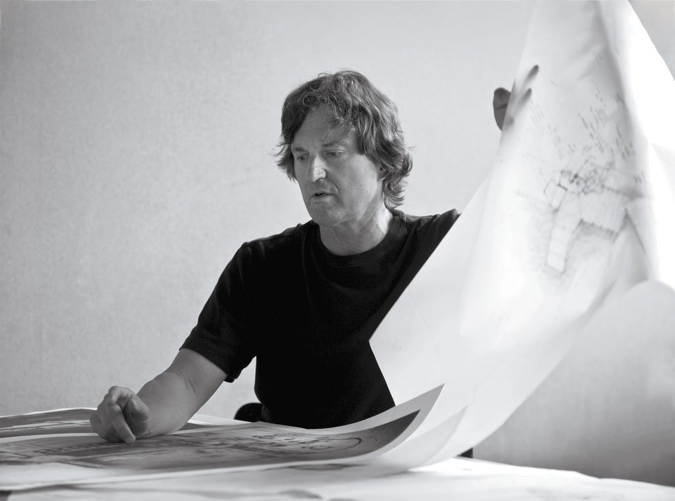 Individual holding a large blueprint. Individual holding a large blueprint.