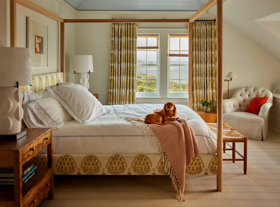 Cozy bedroom featuring a bed with a dog resting on it. Cozy bedroom featuring a bed with a dog resting on it.