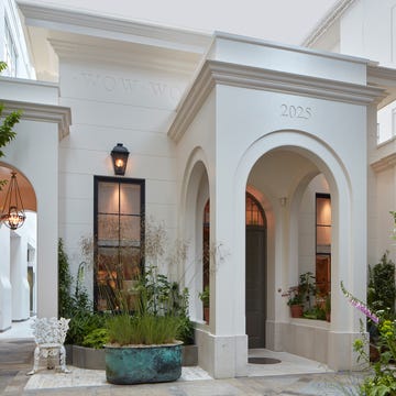 Architectural entryway featuring arched doorways and greenery.