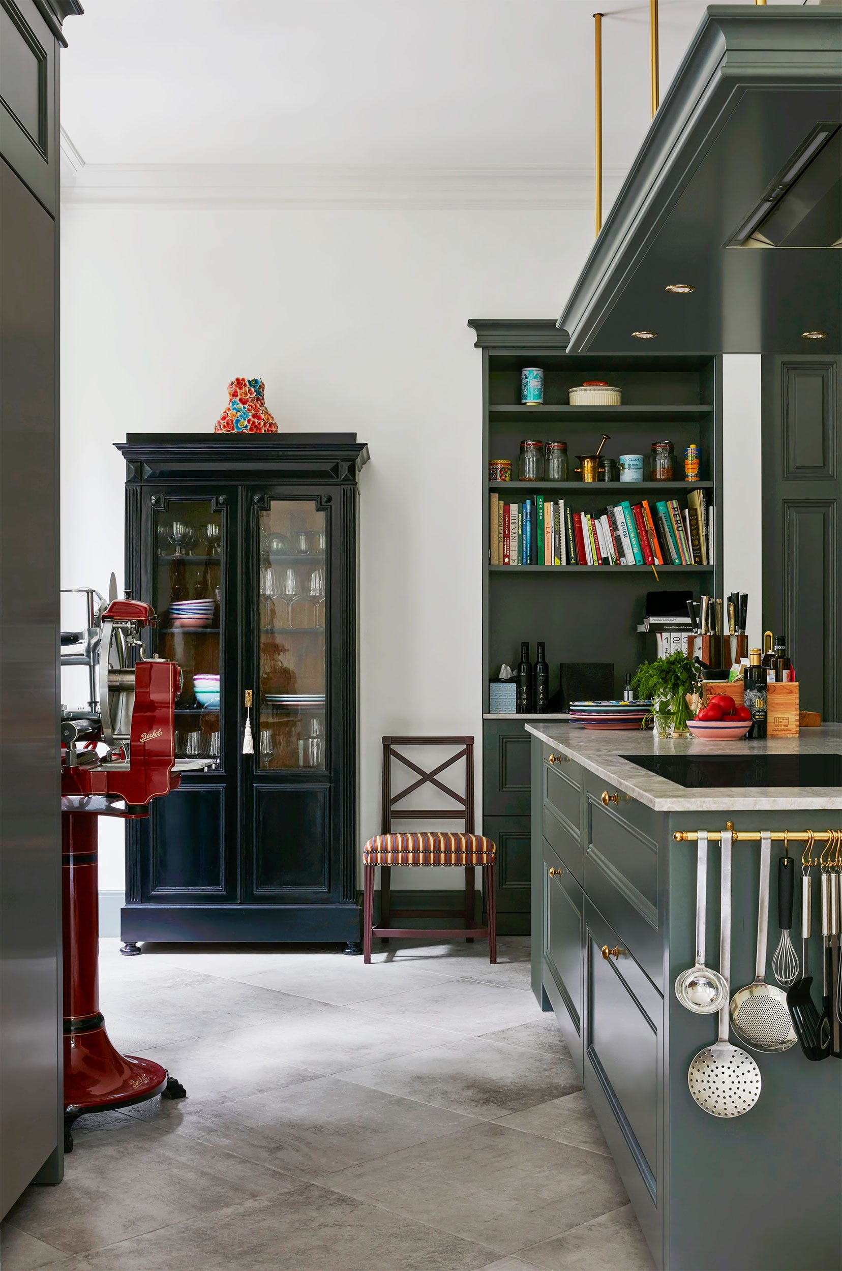 modern kitchenin a slate green and dark green cabinetry and island and colorful decor