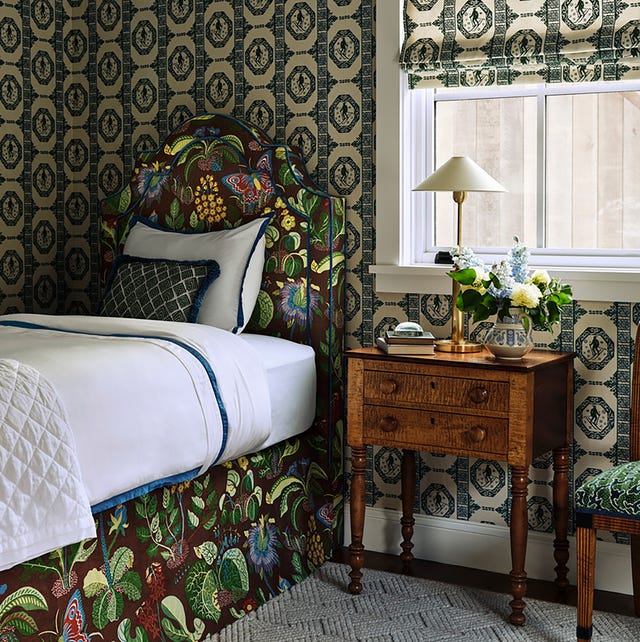 Cozy bedroom featuring a floral headboard and vintage furniture