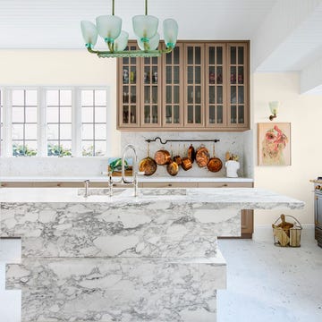 a white house with a window and a table with a white table and a white wall with a