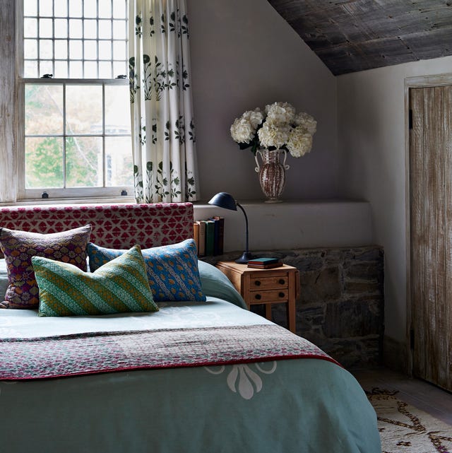 cozy bedroom with boho reupholstered headboard out of a pakistani textile