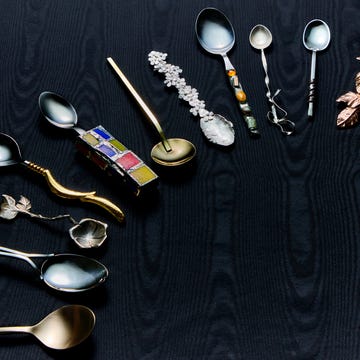 a selection of artisanal spoons ranging from gold to silver to mosaic handles and pieces with ribbon details on a black moire background