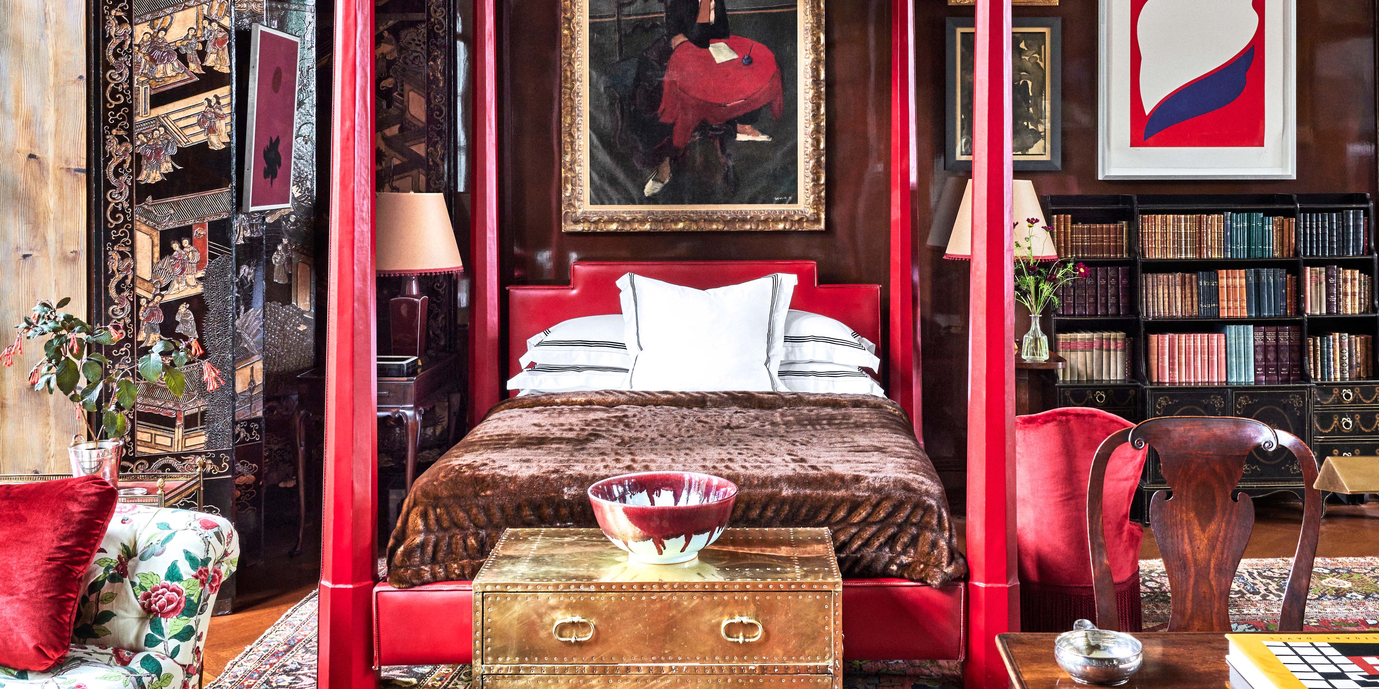 red canopy bed in living room designed by redd kaihoi