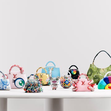 11 bags designed by takashi murakami for louis vuitton on a white table.