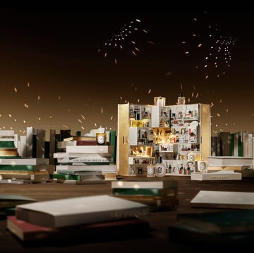 shot of diptyque's advent calendar surrounded by books.