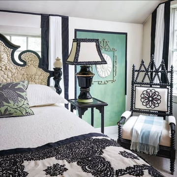 A stylish bedroom featuring a decorative bed and unique furniture.